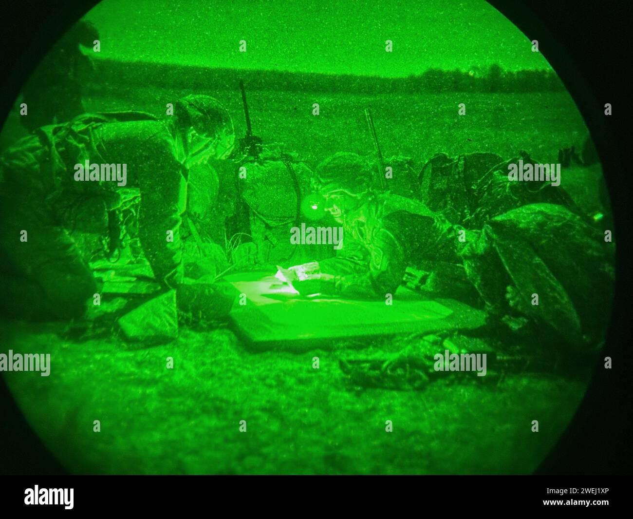 As seen through a night-vision device, U.S. paratroopers conduct a night  airborne operation from a