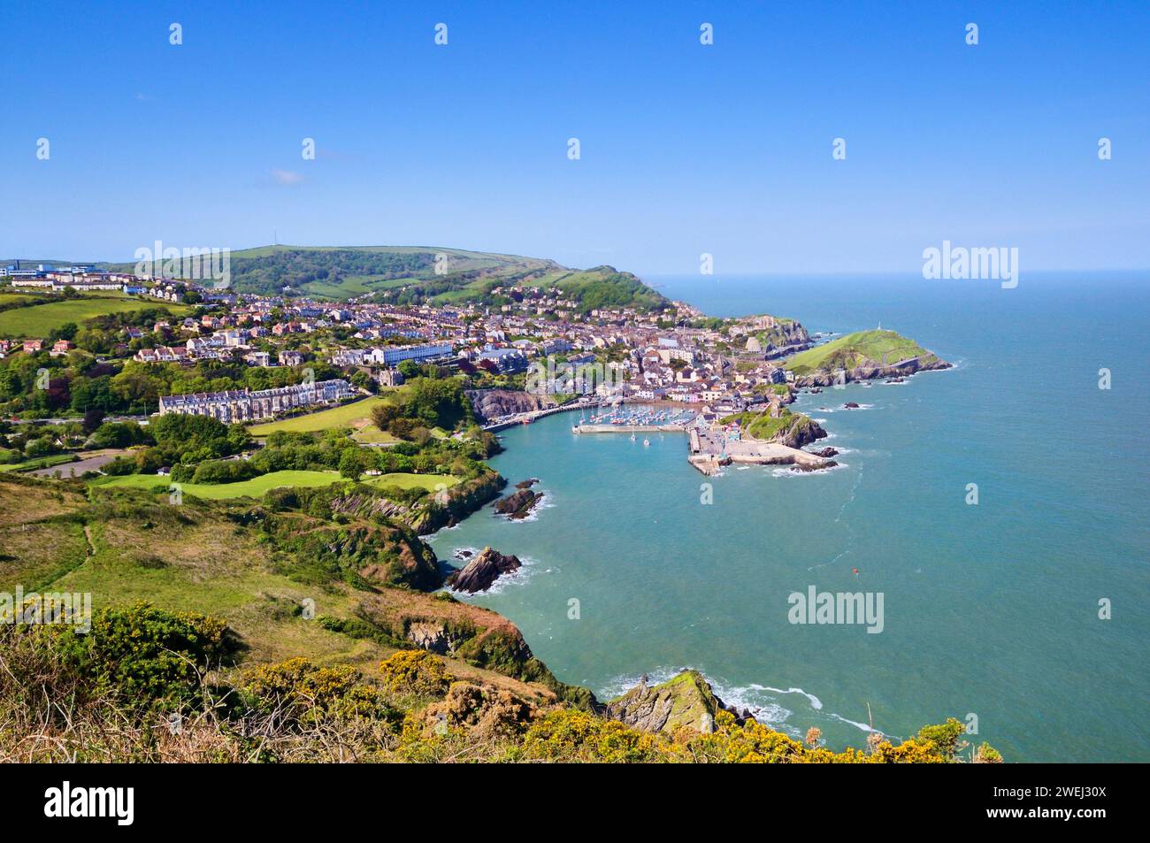 Sunny sea view of Ilfracombe town and coastline from cliff at Hillsborough Park Nature Reserve on the South West Coast Path, North Devon, England, UK Stock Photo