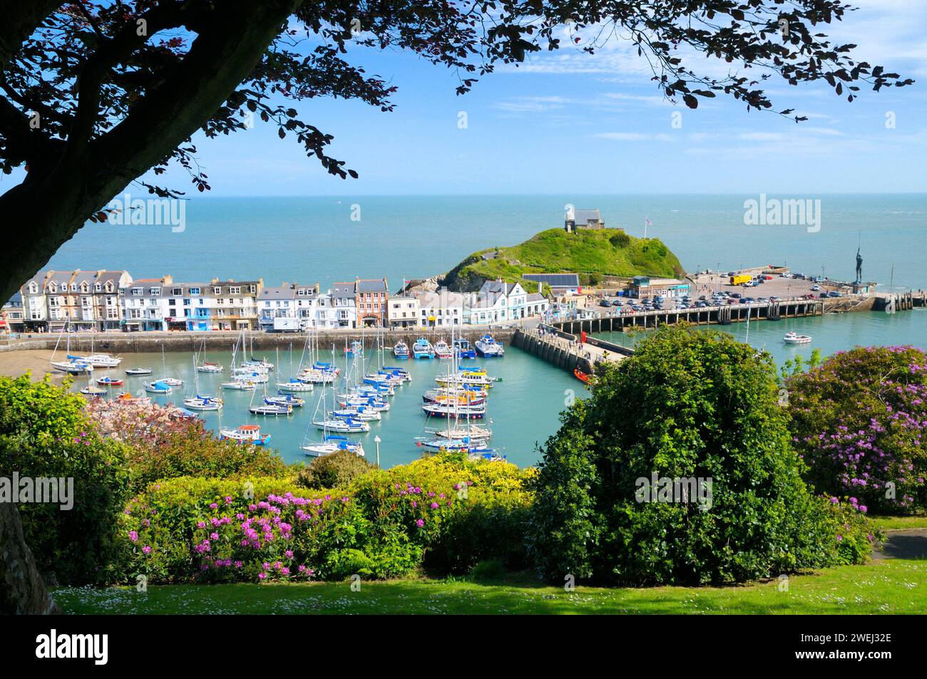 Sunny sea view of Ilfracombe with boats and yachts in harbour and buildings along the quay beneath St Nicholas Chapel, North Devon coast, England, UK Stock Photo