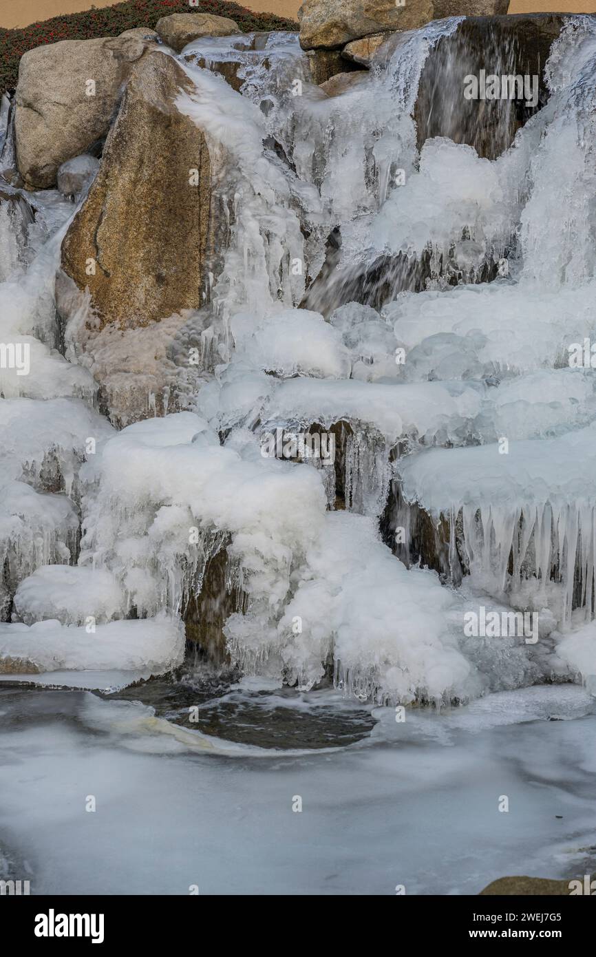 A frozen water feature in winter in the garden of the Shumway