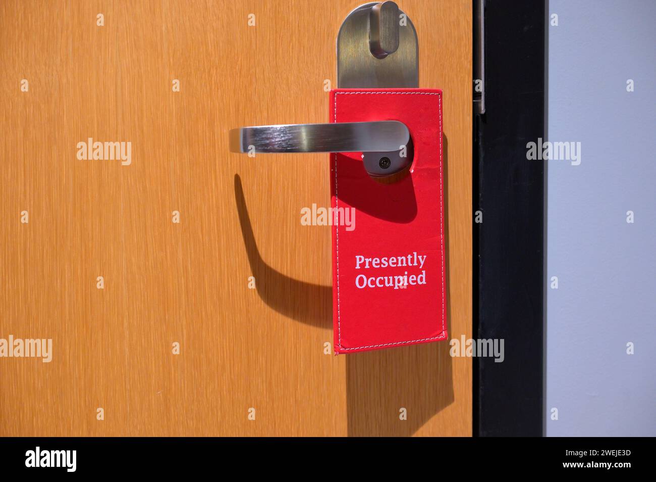 Presently Occupied - do not disturb sign on a guest room Stock Photo