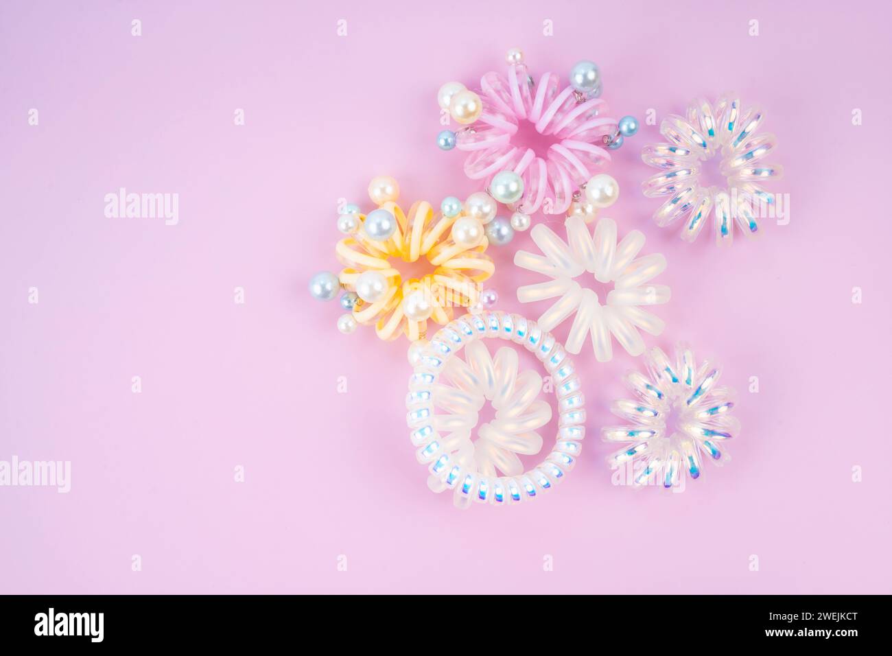 Colorful plastic hair elastics set on beautiful background Stock Photo