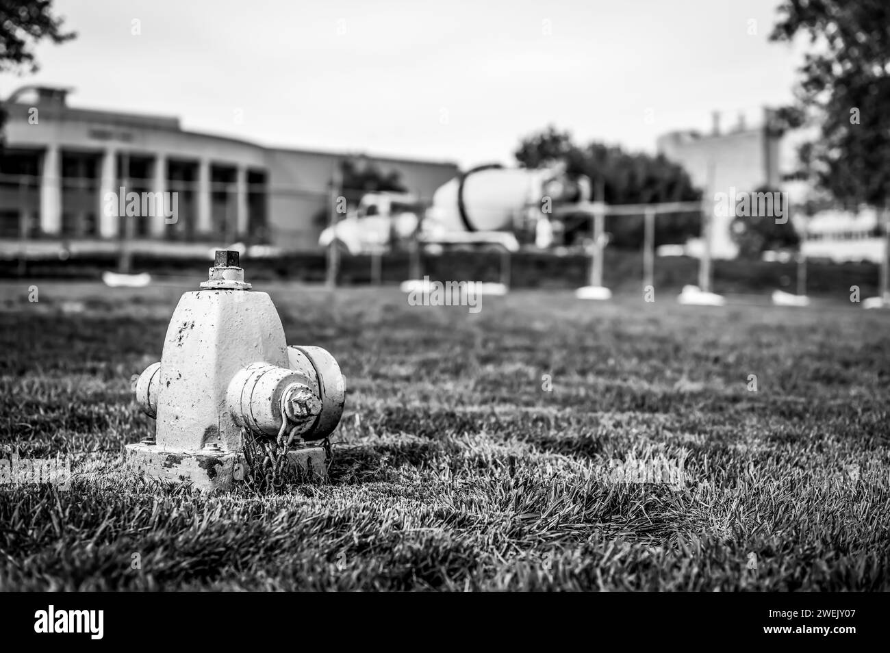 Sunken low level dry barrel fire hydrant in an open grassed area Stock Photo