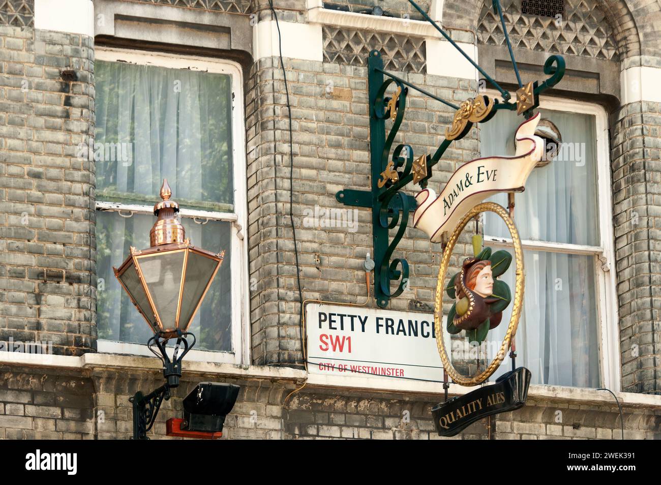 LONDON, UK - MAY 24, 2010:  Adam and Eve Pub sign close to Petty France street sign Stock Photo