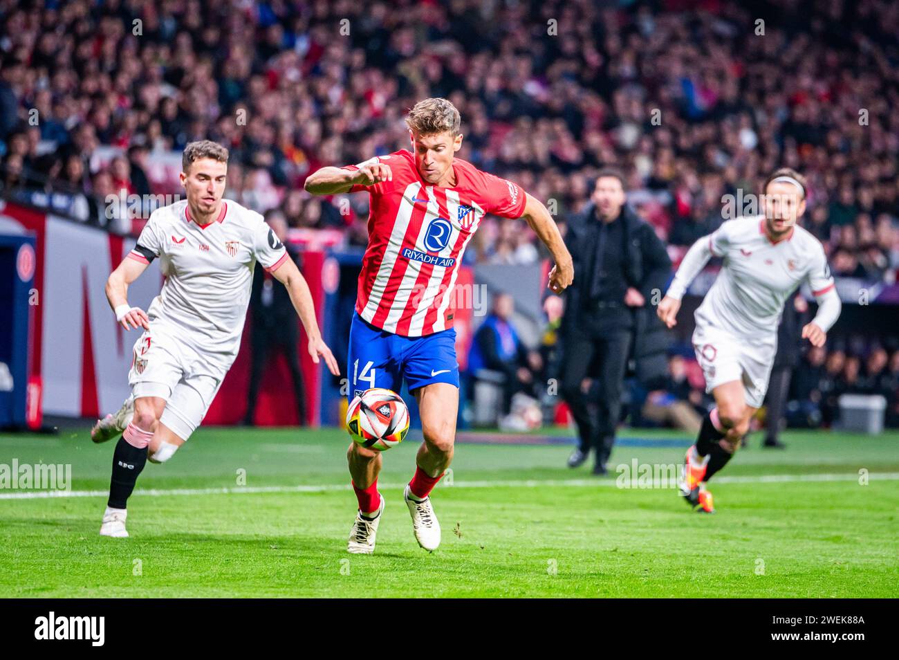 Madrid, Spain. 25th Jan, 2024. Marcos Llorente (C) of Atletico Madrid and Adria Pedrosa (L) and Ivan Rakitic (R) of Sevilla in action during the football match valid for quarter finals of the Copa del Rey tournament between Atletico Madrid and Sevilla played at Estadio Metropolitano. Atletico Madrid 1 : 0 Sevilla Credit: SOPA Images Limited/Alamy Live News Stock Photo