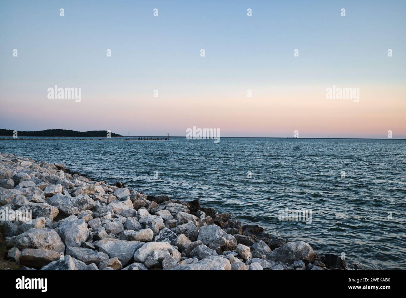 Calm waves on rocky shoreline hi-res stock photography and images - Alamy