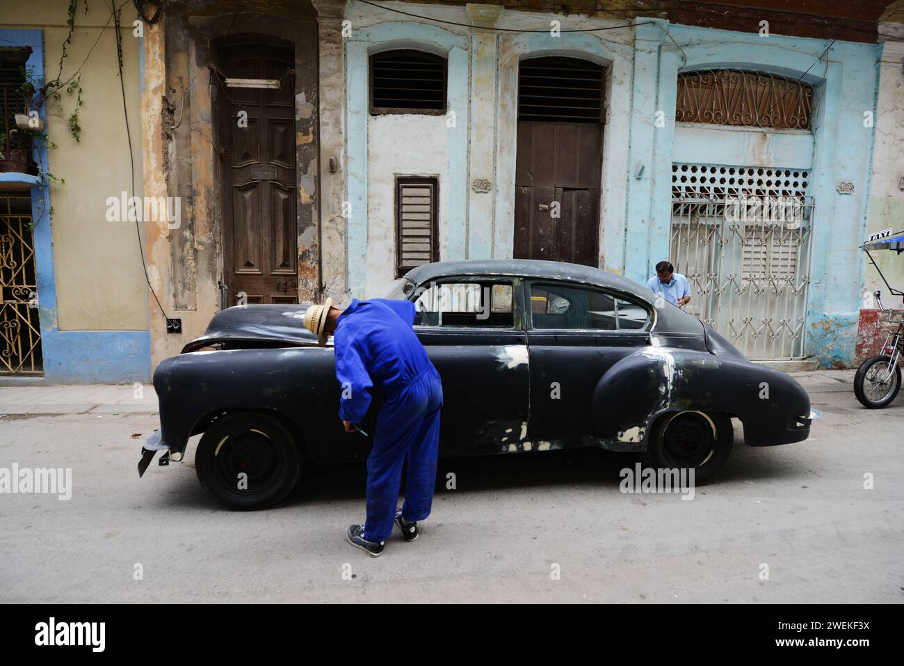 Fixing an old Chevrolet car on the street in Old Havana, Cuba. Stock Photo