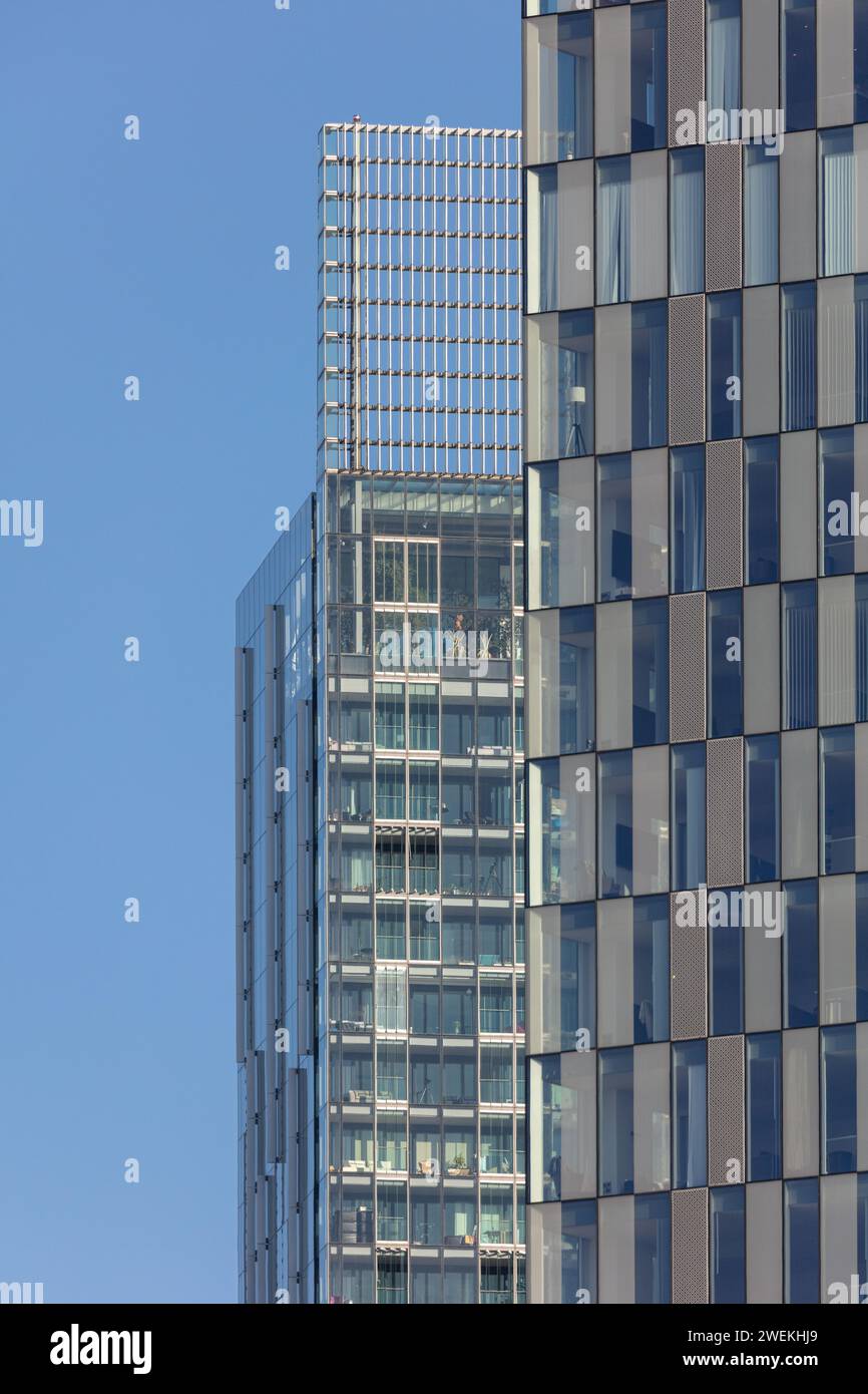 Portrait image of a Deansgate Square residential tower in the foreground with Beetham Tower peeking out in the background on a sunny Manchester, UK Stock Photo