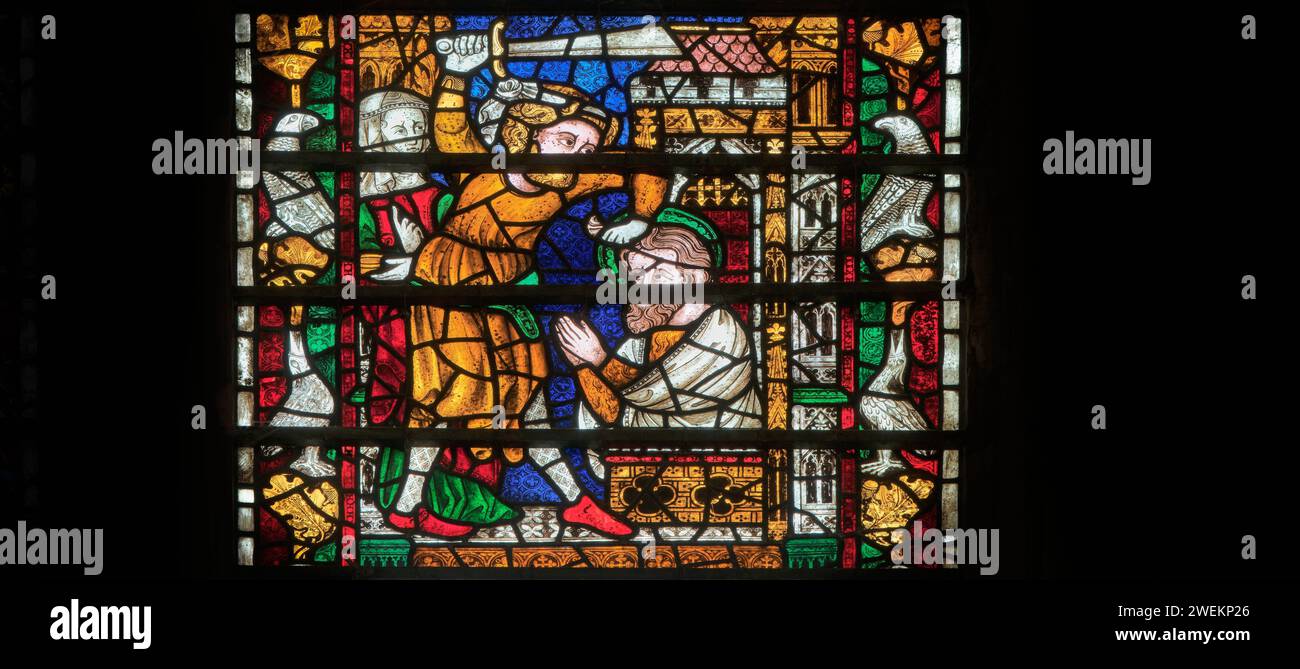 Medieval stained glass window, of a saint being killed, in the cathedral at York, England. Stock Photo