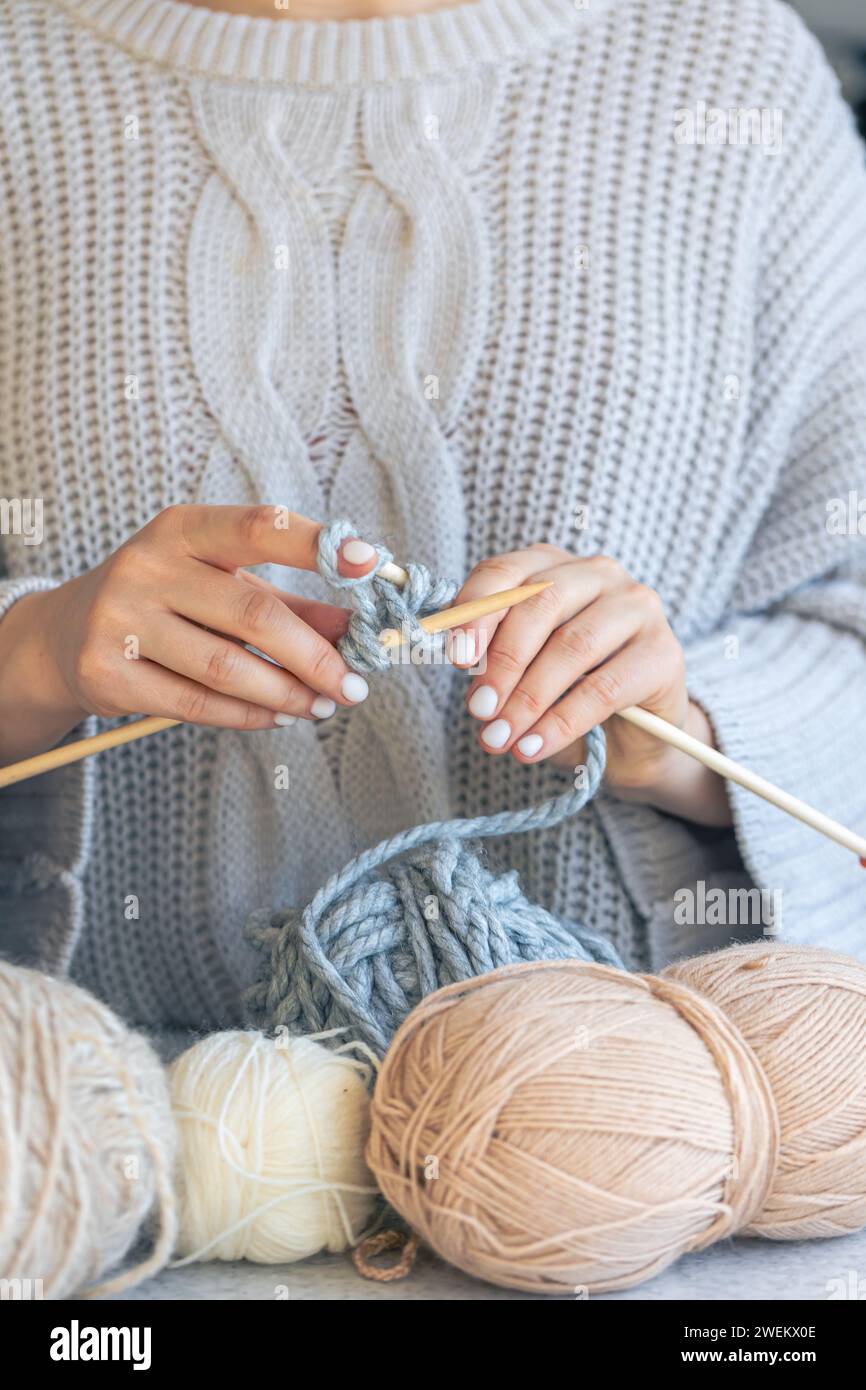Close-up of hands knitting using circular needles. Stock Photo