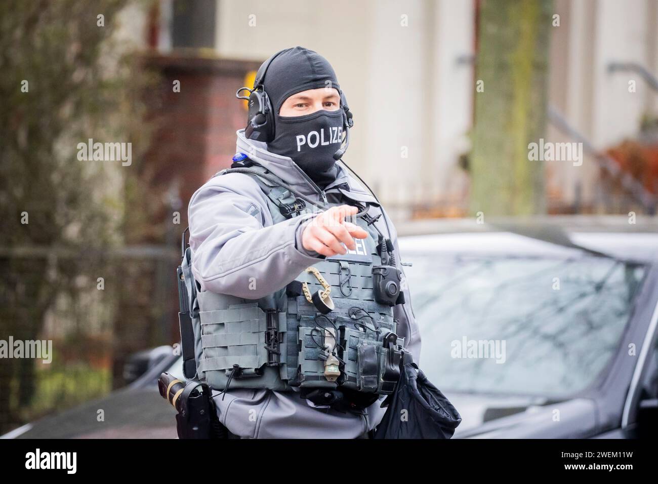 Berlin, Germany. 26th Jan, 2024. A police officer is on duty outside a villa belonging to a clan in the Berlin district of Buckow in the Neukölln borough. Due to the attack on a policewoman by a clan member on New Year's Eve, there was another police operation at the villa of the extended family. According to the police, there is no connection with the planned eviction of the villa by the Neukölln district. Credit: Christoph Soeder/dpa/Alamy Live News Stock Photo