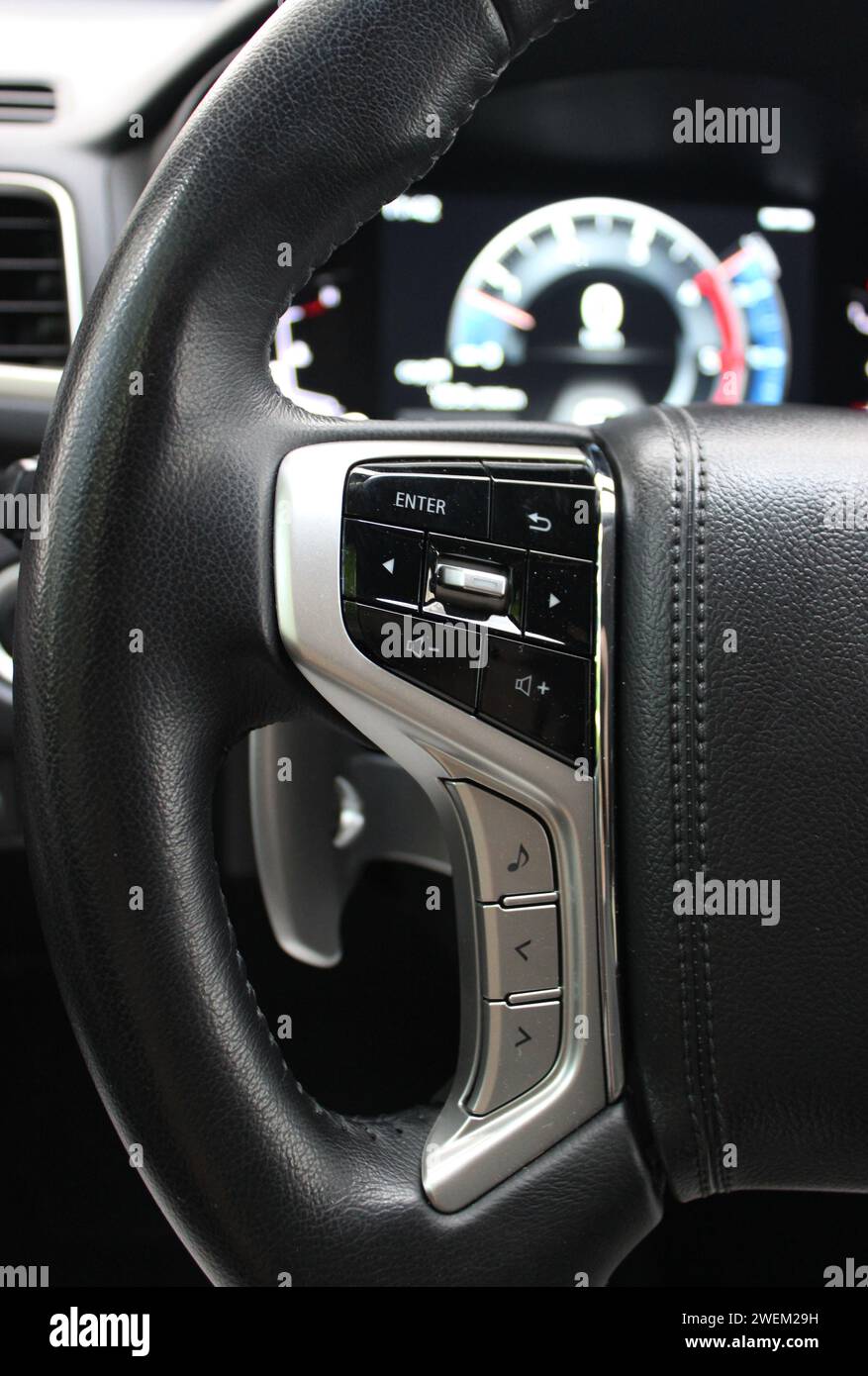 Buttons And Electronic Control Panel On A Steering Wheel And Blurred