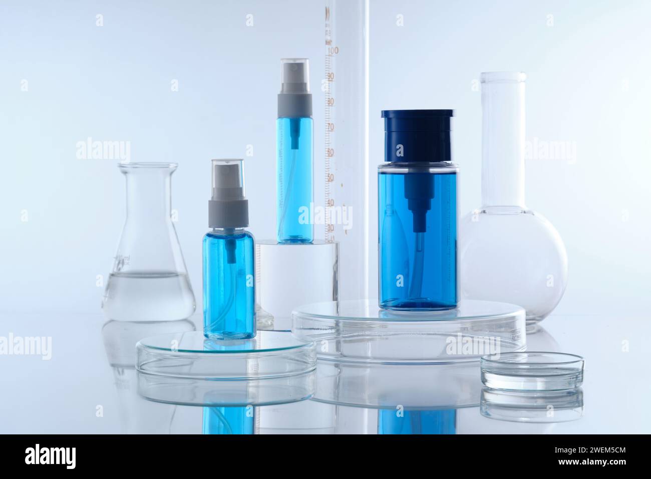 Mockup scene for cosmetic with three blue spray bottle without label ...