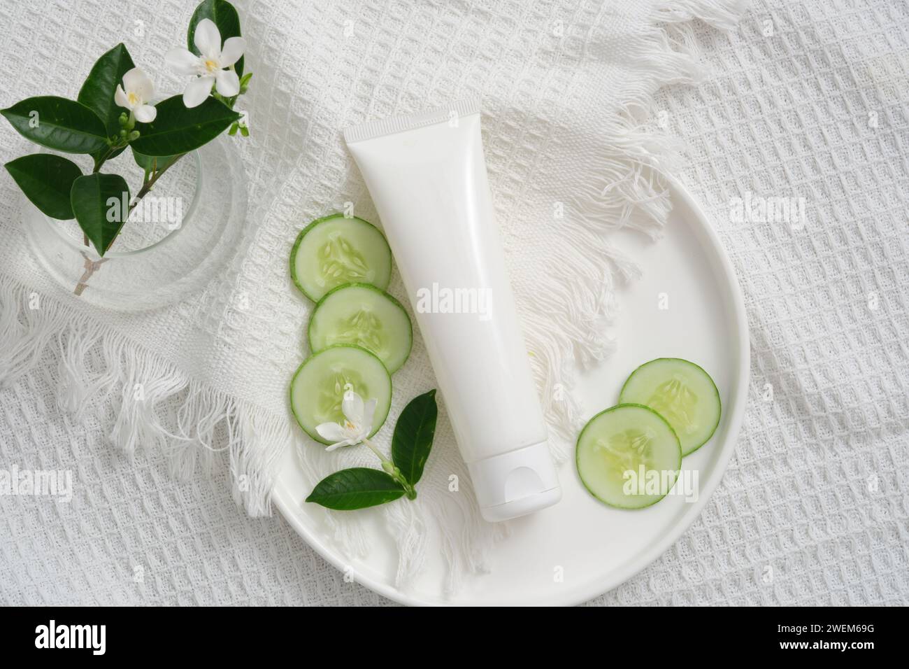 Image showcasing Mockup scene for cosmetic of cucumber extract. Plastic tube, cucumber ...