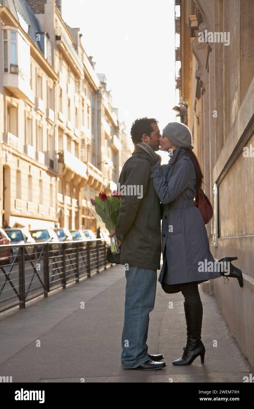 Young couple kissing in a city street Stock Photo - Alamy