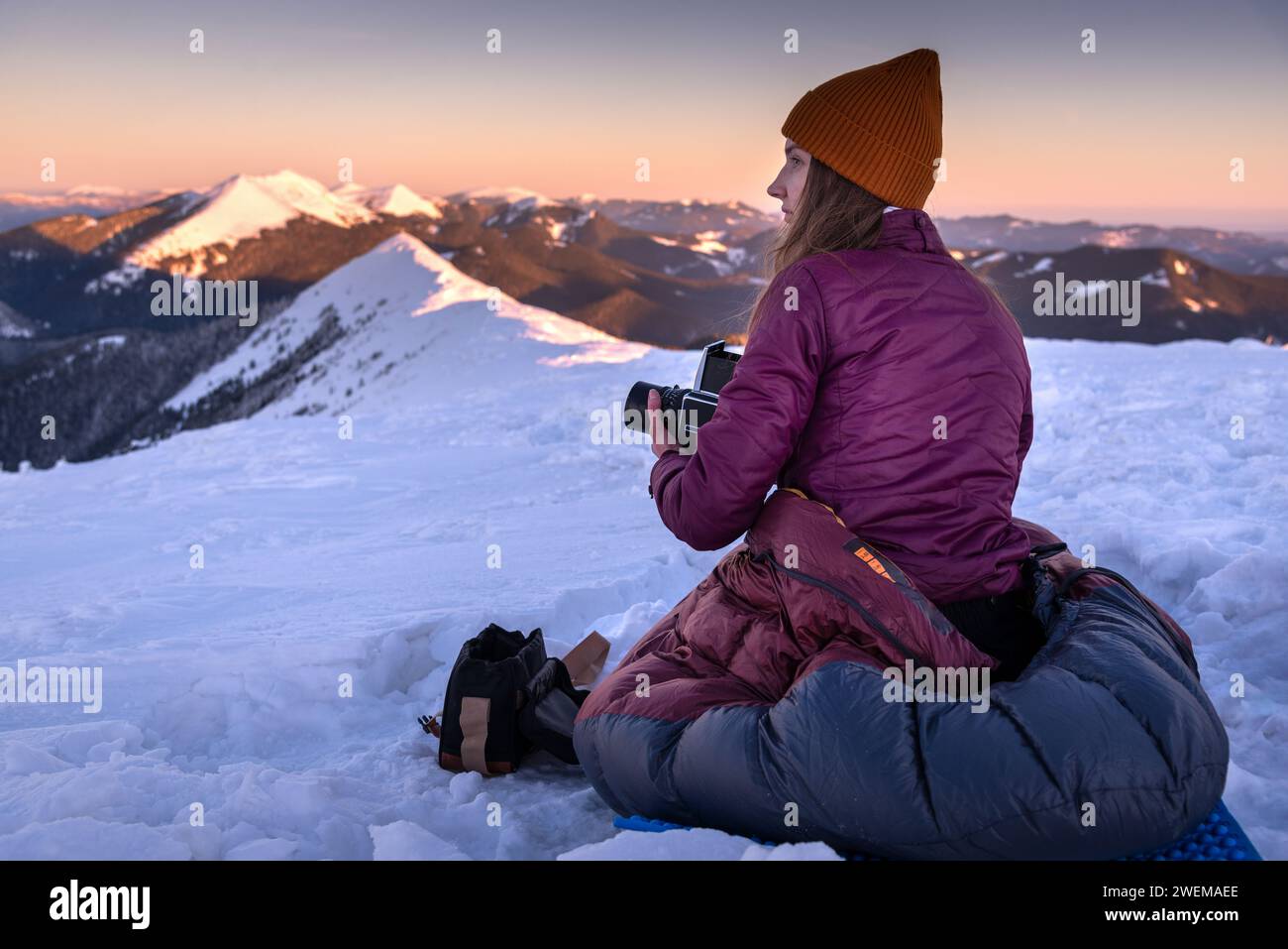 Woman Photographing on Hasselblad sunrise in Winter Mountains Stock Photo