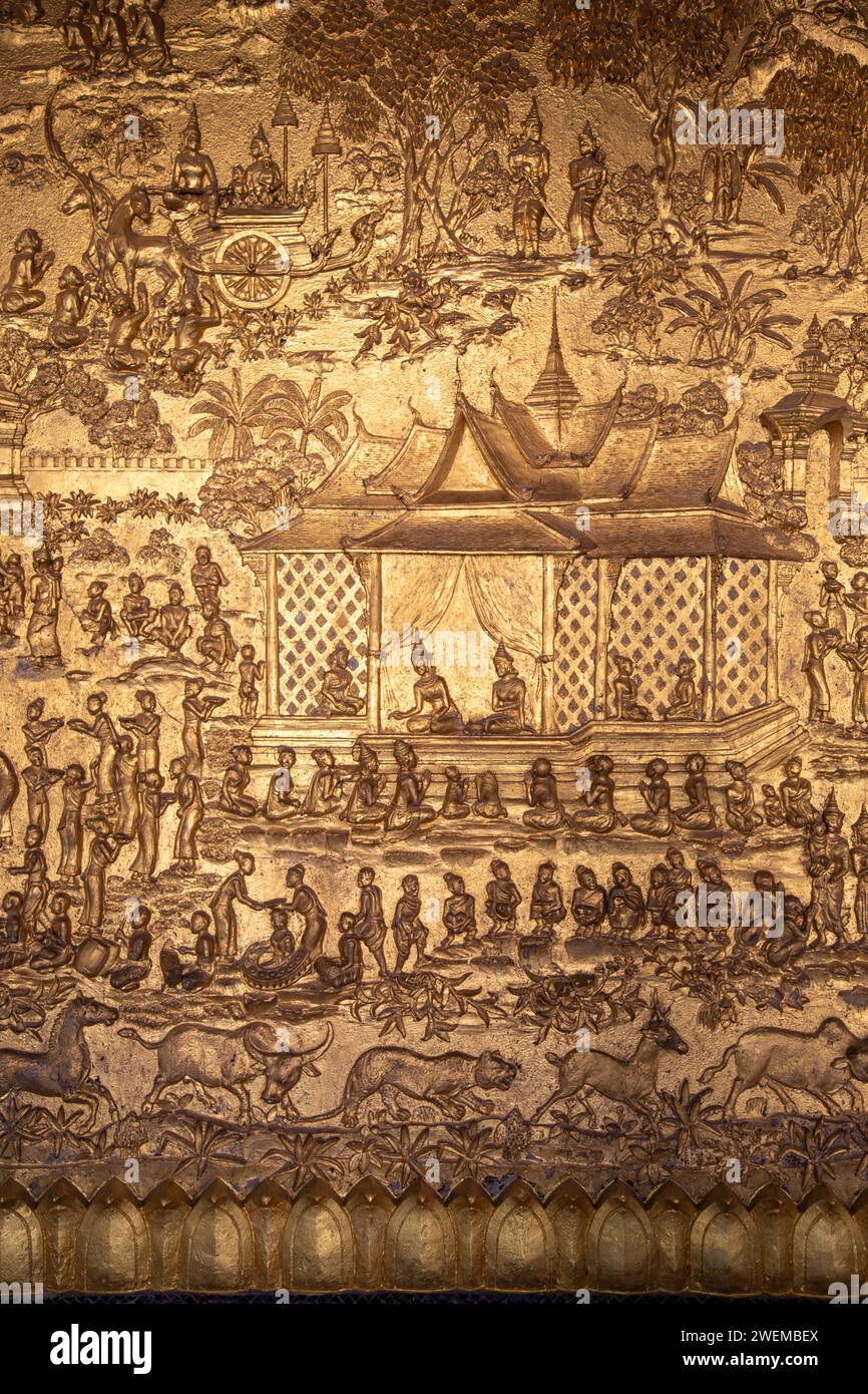 Golden carvings of Buddhist history on a Temple's wall Stock Photo