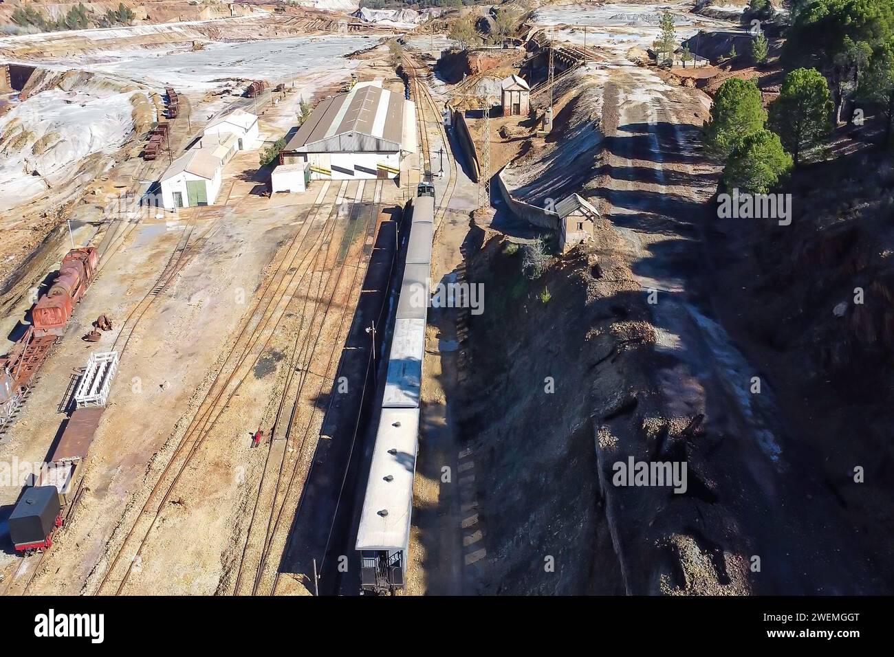 Aerial drone view of the old tourist train on a tour of the remains of the copper mine exploitation named Corta Atalaya, in the town of Minas de Rioti Stock Photo