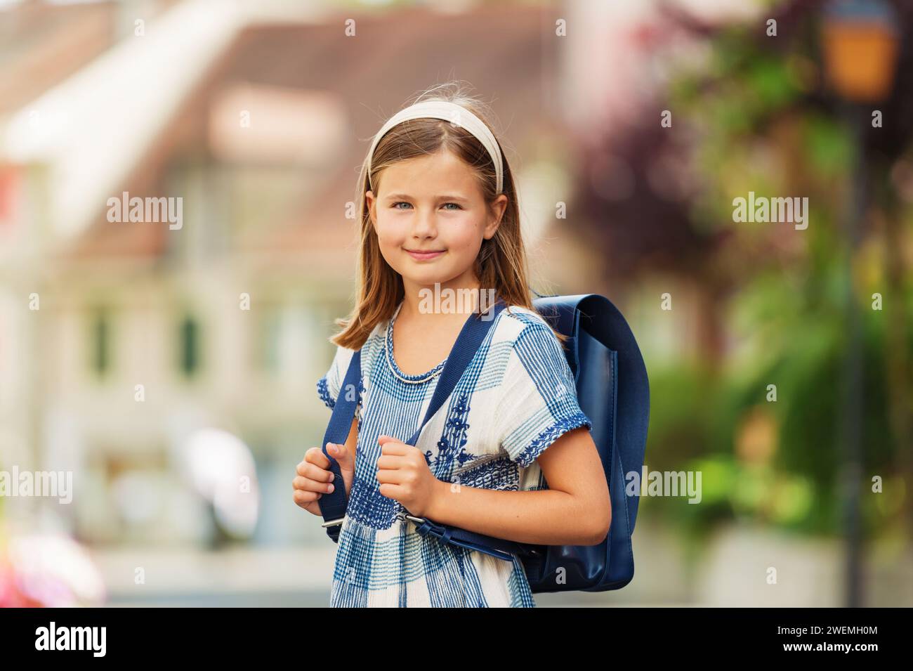 Pretty little 9 year old girl walking back to school Stock Photo - Alamy