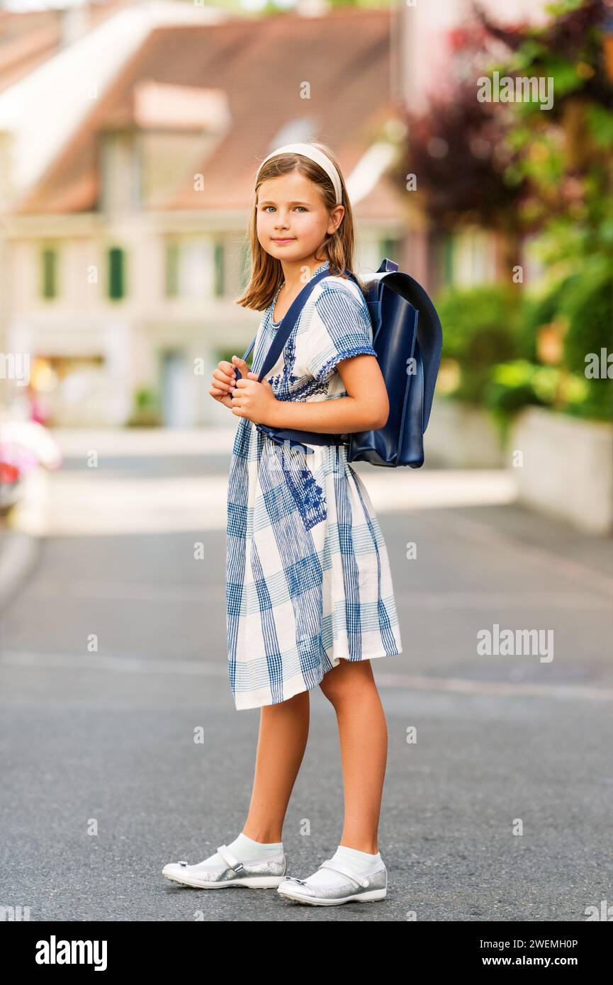 Pretty little 9 year old girl walking back to school Stock Photo - Alamy