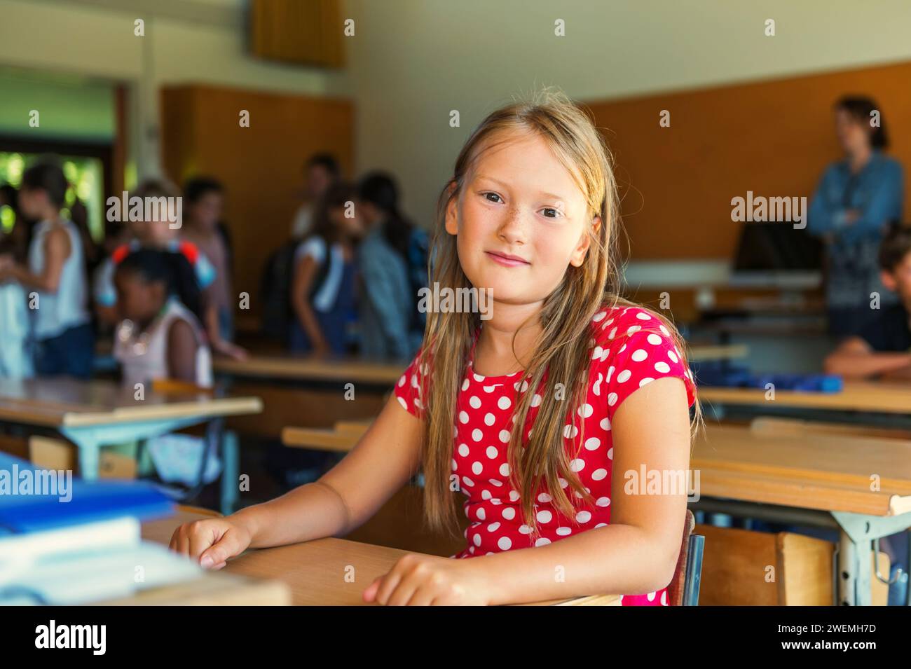 Indoor portrait of a cute little girl in a classroom Stock Photo - Alamy