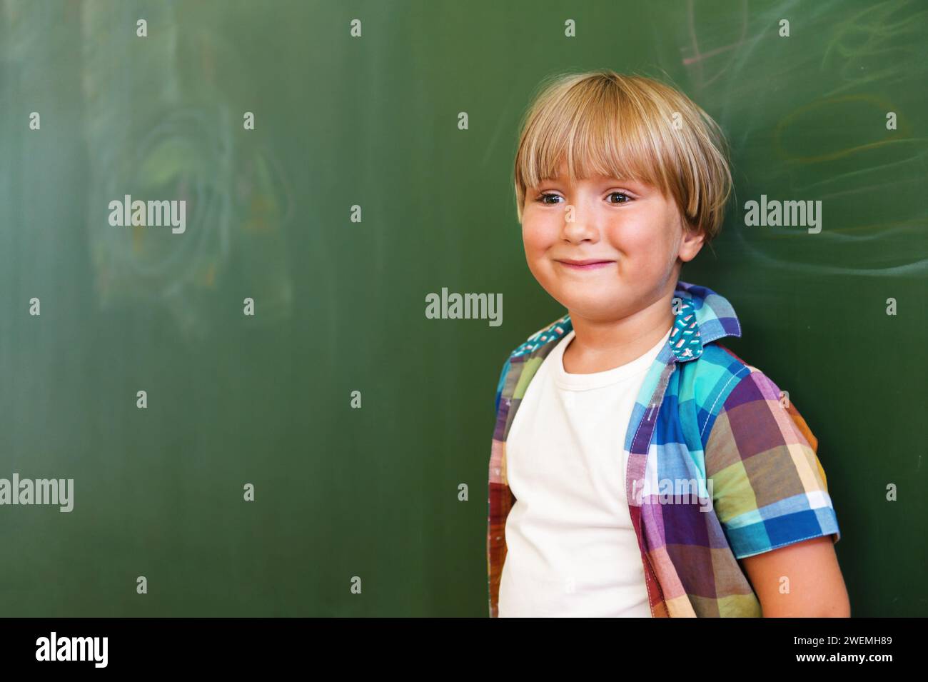 Indoor portrait of a cute little boy in a classroom Stock Photo - Alamy