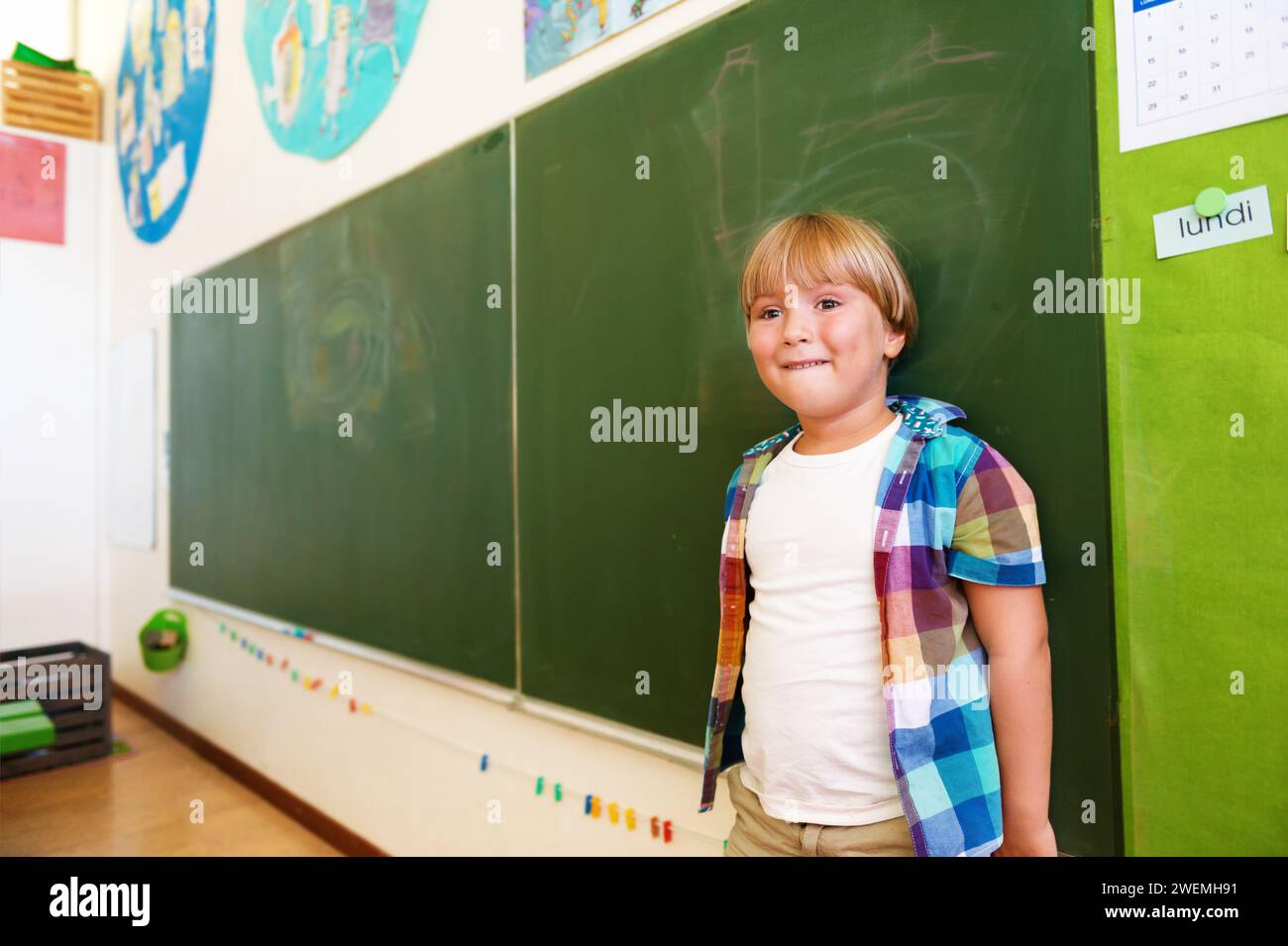 Indoor portrait of a cute little boy in a classroom Stock Photo - Alamy