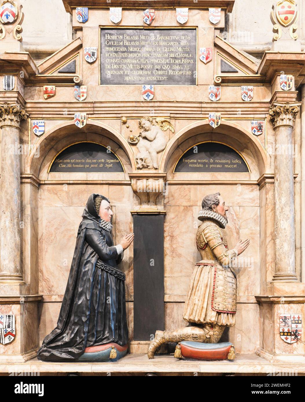 Statues, of a pious couple hoping to be as well off in the afterlife as they were in earthly life, on a wall at the minster (cathedral), York, England. Stock Photo