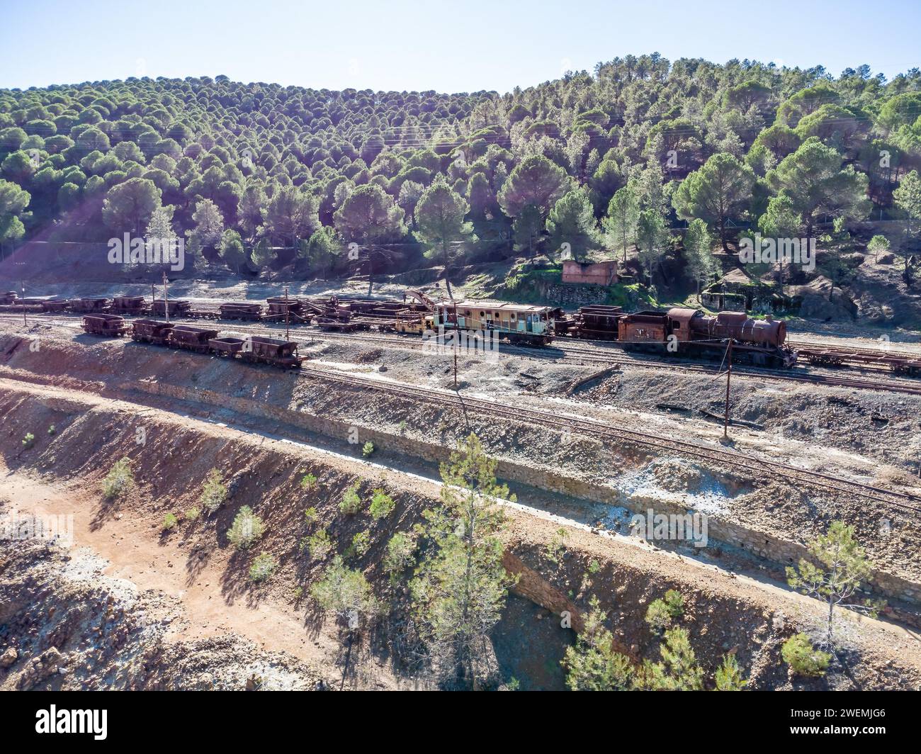 Aerial drone view of old and rusty steam mining train, electric train and wagons used for transportation of the copper of  Corta Atalaya mining exploi Stock Photo