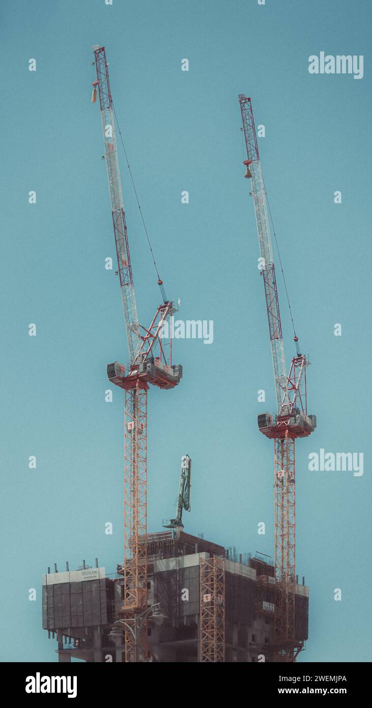 Low angle of construction cranes on building Stock Photo - Alamy