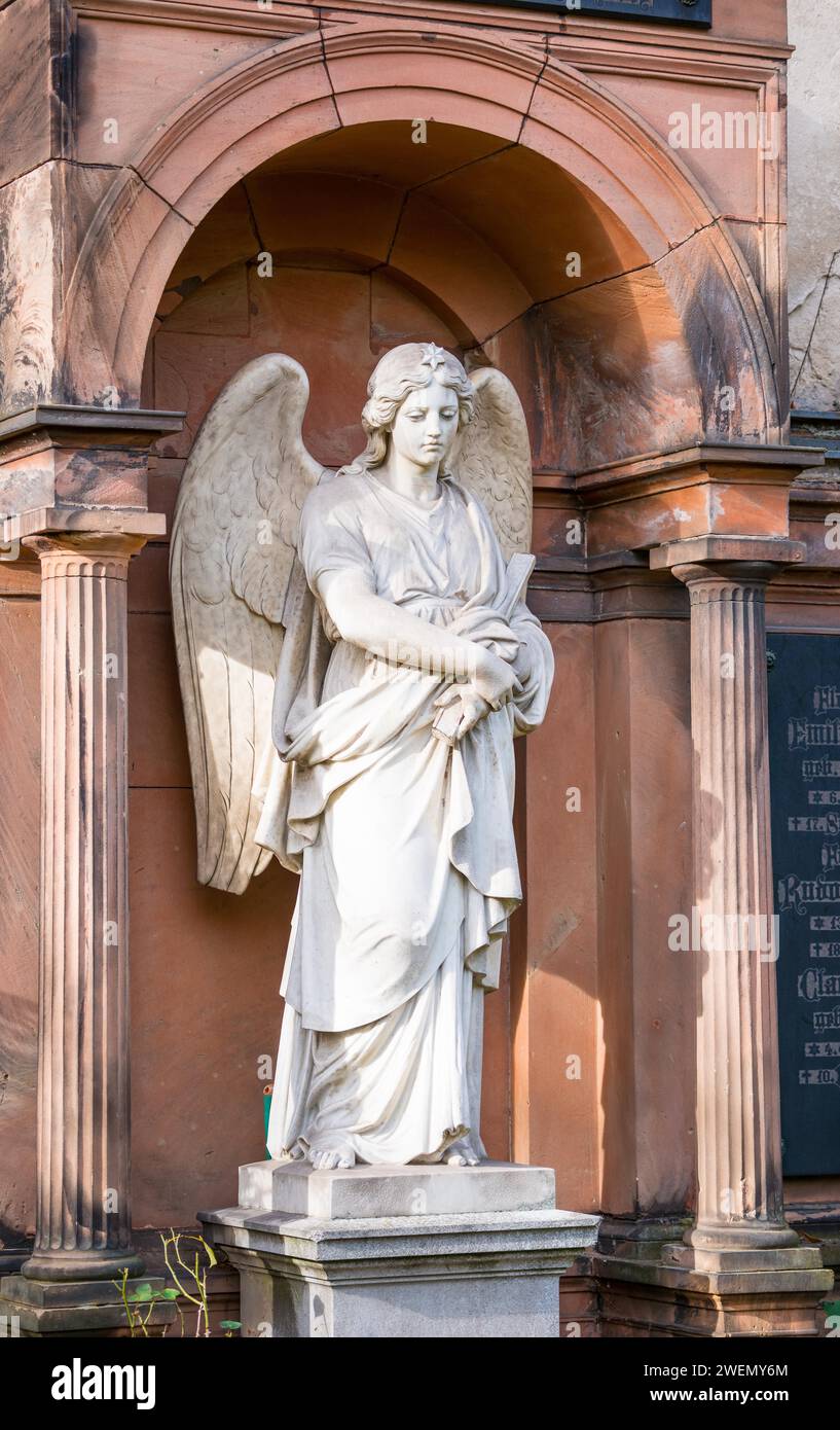 White angel statue with folded arms and spread wings in front of an arch, White, female angel figure, angel statue with star on the crown, finely Stock Photo