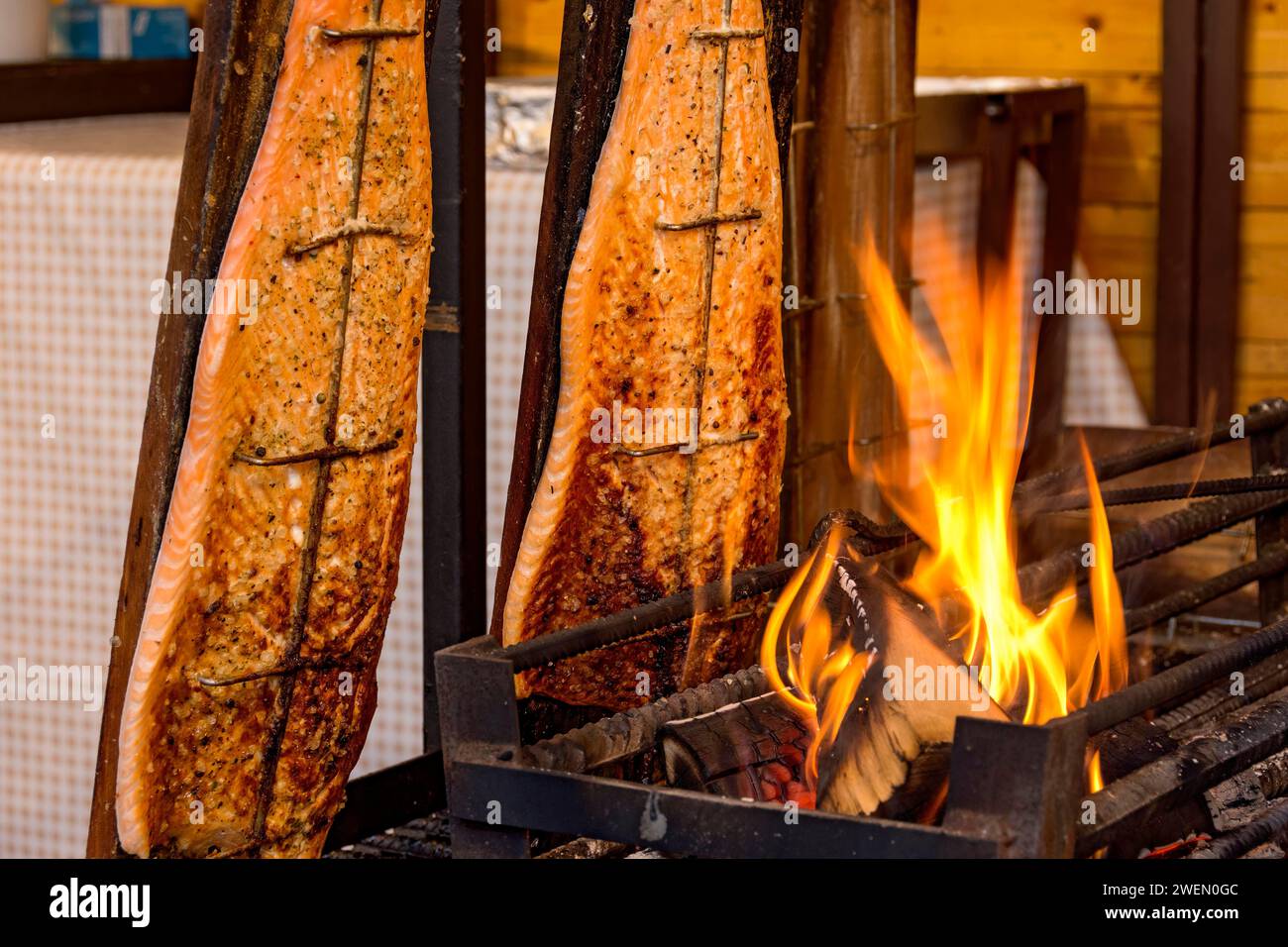 Flamegrilled salmon in a fire bowl, fillets of salmon grilled over an
