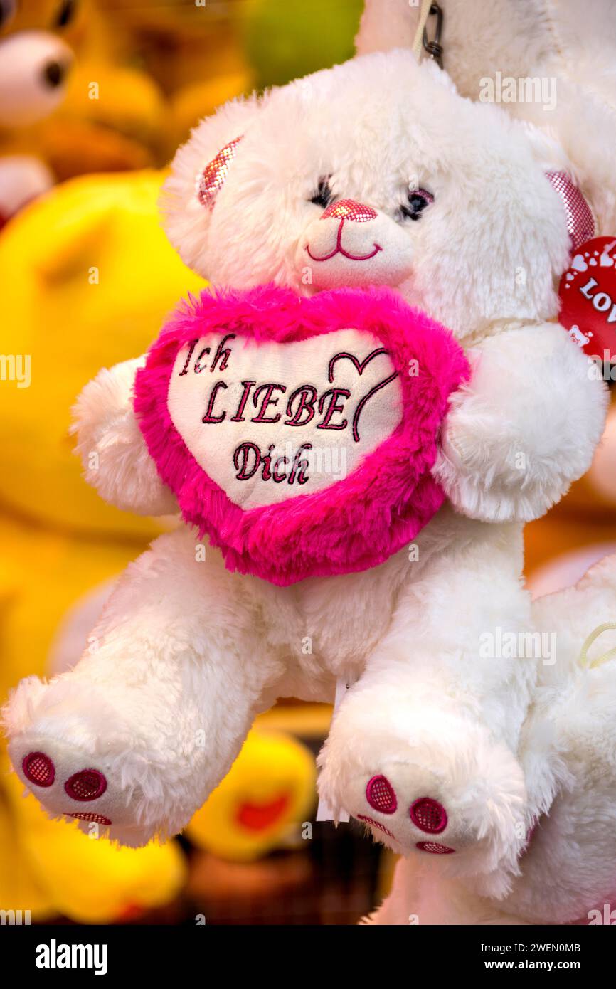 Teddy bear, plush toy with pink heart, I love you, prizes, raffle prizes, lucky draw, lottery stand, lottery booth at Kalter Markt, Kaale Maeaert Stock Photo