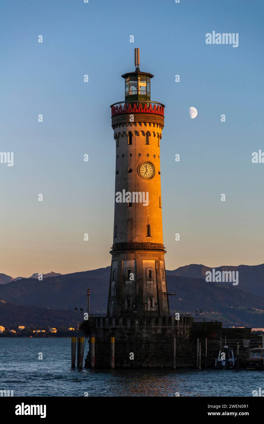 Lindau at Lake Constance, entrance to the harbour, new lighthouse, view of the Alps, half moon, evening light, Bavaria, Germany Stock Photo