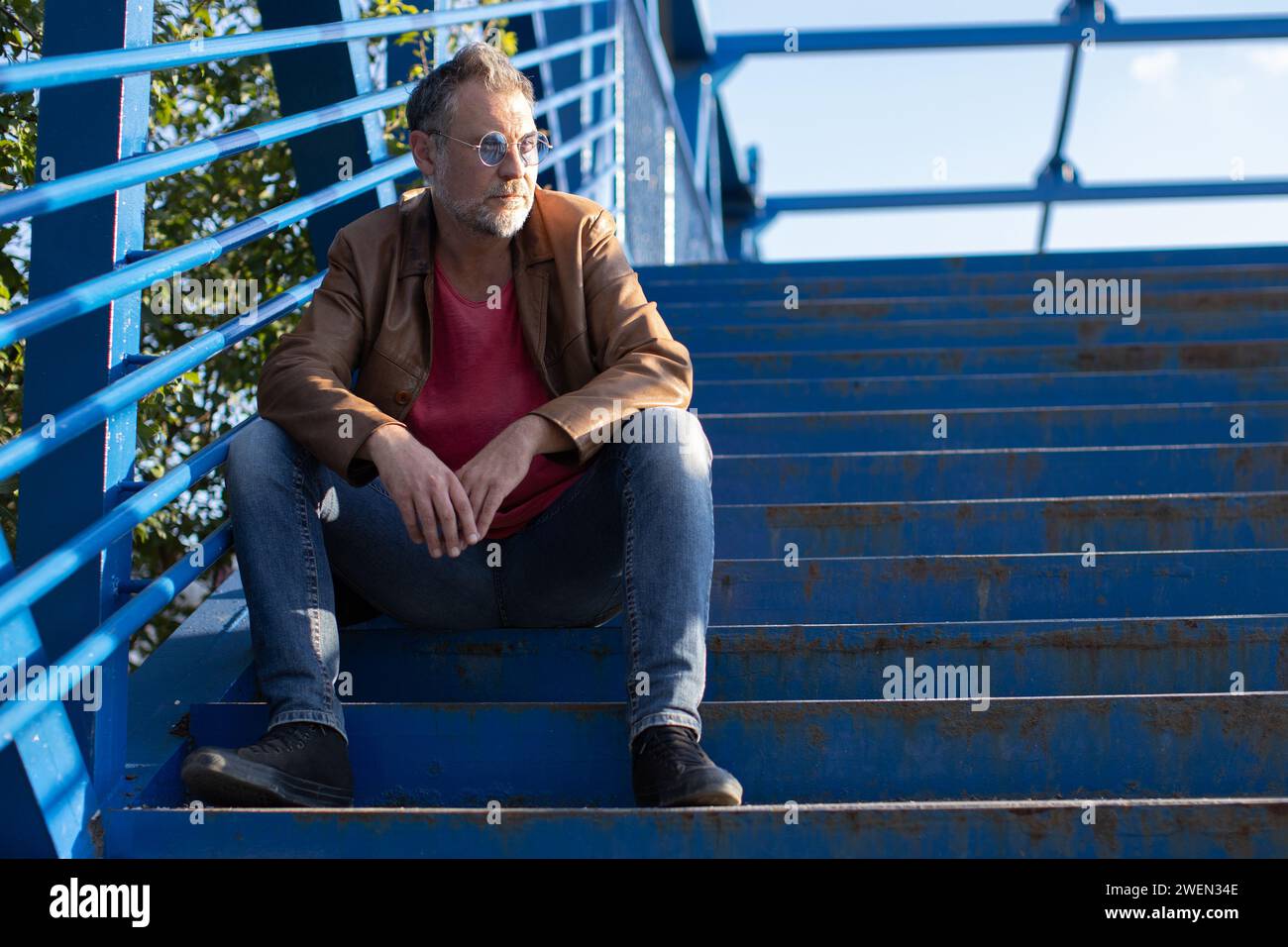 Lonely man sitting on stairs hi-res stock photography and images - Alamy