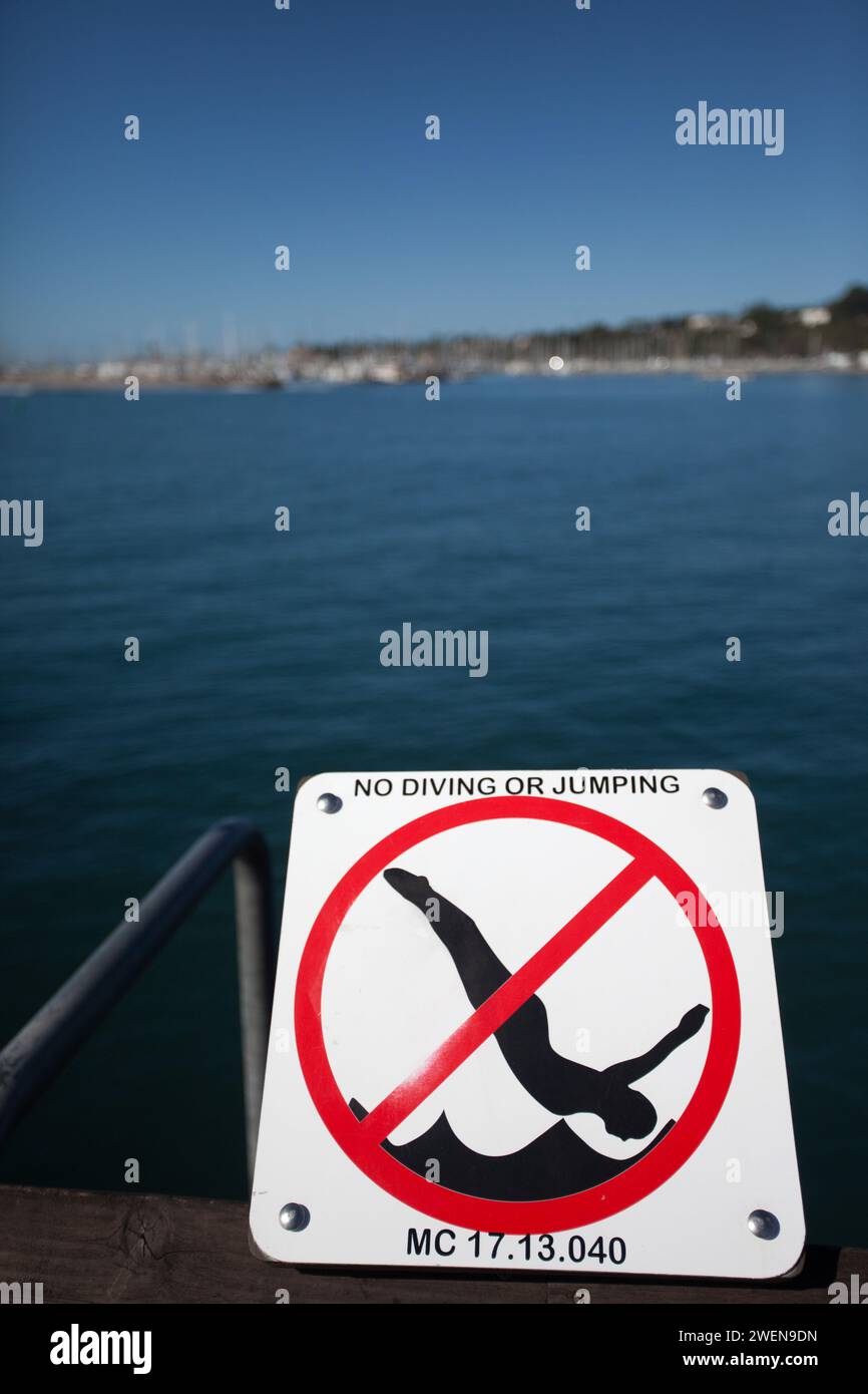 Signage along Santa Barbara Pier in California, also known as Stearns Wharf instructing and warning people not to dive from the wharf. Stock Photo