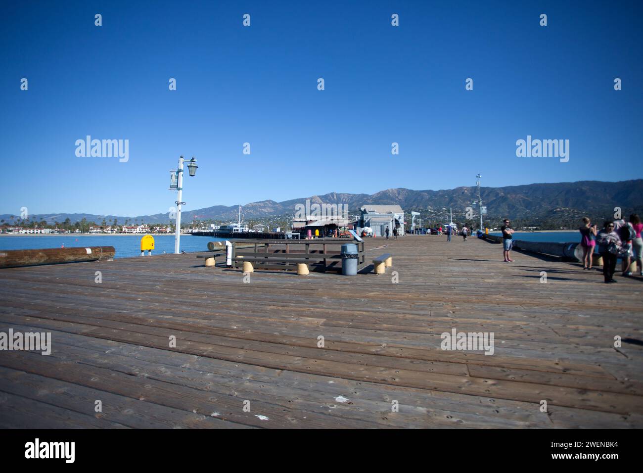 Scene looking back along Santa Barbara Pier in California, also known as Stearns Wharf which was completed in 1872 by John P Stearns. Stock Photo