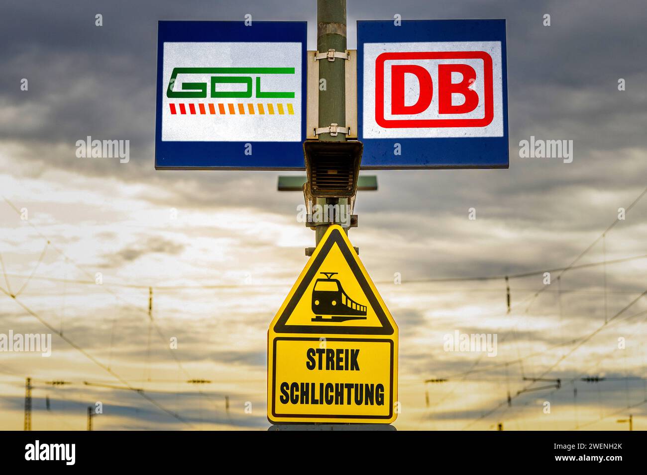 January 26, 2024: GDL Gewerkschaft Deutscher Lokomotivführer and DB Deutsche Bahn logo on a board at a train station with a warning sign saying strike arbitration PHOTO ASSEMBLY *** GDL Gewerkschaft Deutscher Lokomotivführer und DB Deutsche Bahn Logo auf einer Tafel an einem Bahnhof mit einem Warnschild mit der Aufschrift Streikschlichtung FOTOMONTAGE Stock Photo