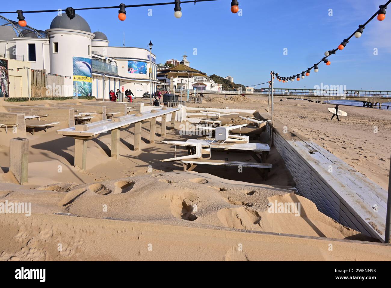 Bournemouth, Dorset, England, UK, 26th January 2024, Weather: Winter sunshine. A beach front restaurant/bar’s outside seating area is buried in sand after recent storms. Credit: Paul Biggins/Alamy Live News Stock Photo