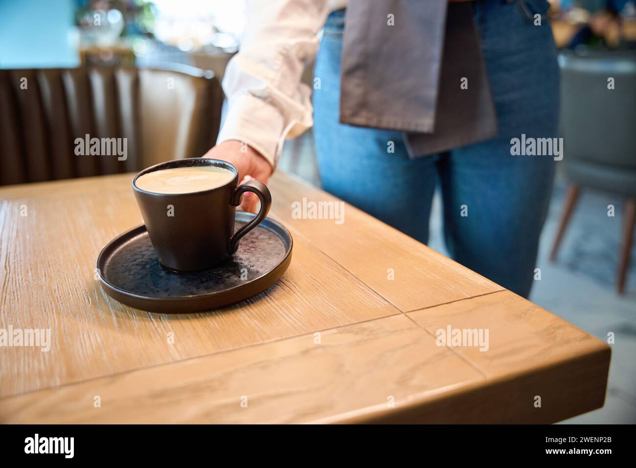 Waiter serves coffee for one person Stock Photo Alamy
