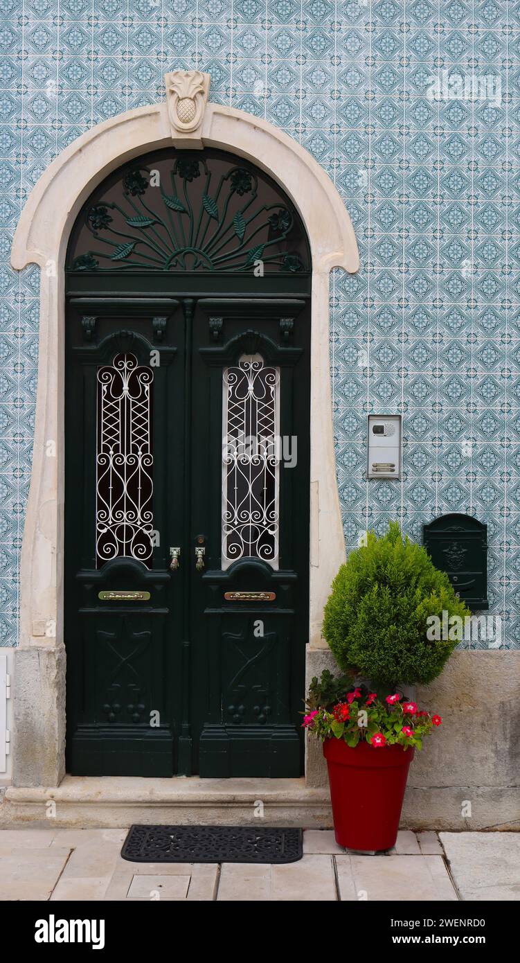 Residential home front door surrounded by traditional Portuguese tiles, Alcobaca, Portugal Stock Photo