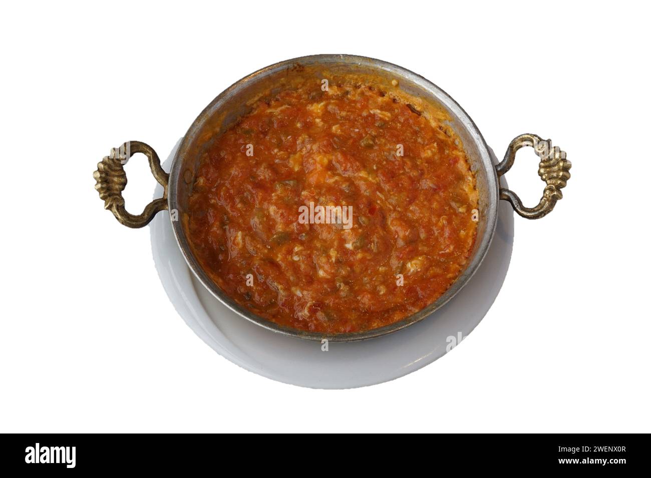 Turkish breakfast dish Menemen, eggs, tomatoes and peppers in a pan. isolated white background Stock Photo