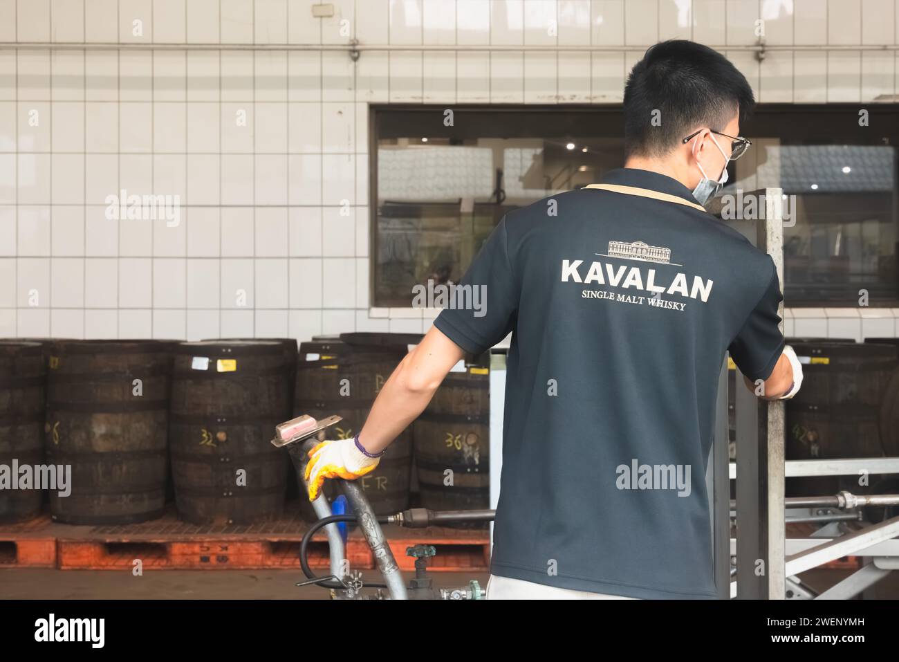 Yuanshan, Republic of China - October 2, 2023: A factory worker at the Kavalan Whisky Distillery, a popular tourist attraction in Yilan County, Taiwan Stock Photo