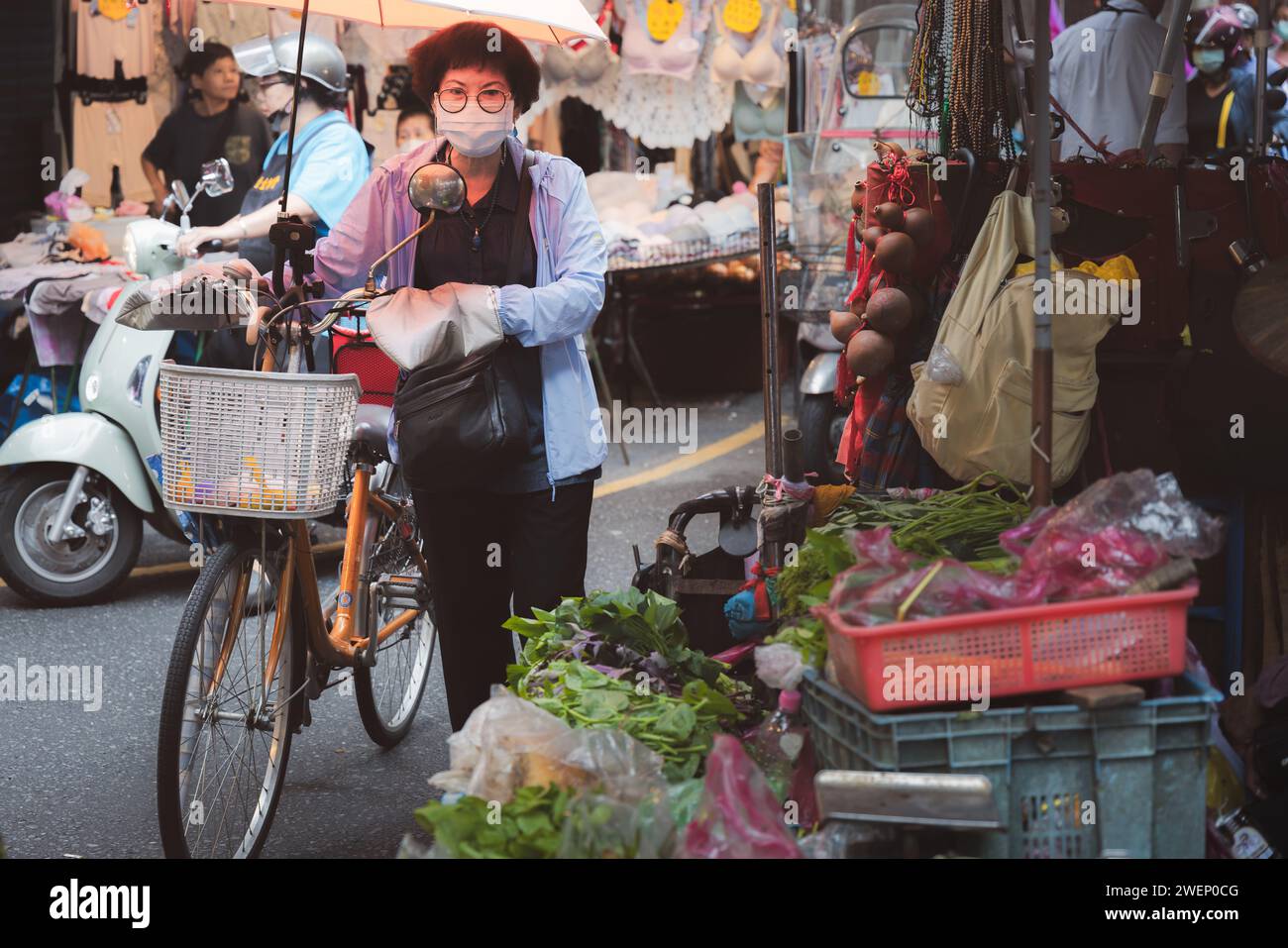 Yilan, Republic of China - October 2, 2023: Street vendors and shoppers at a colourful, bustling day market in the city of Yilan, Taiwan. Stock Photo
