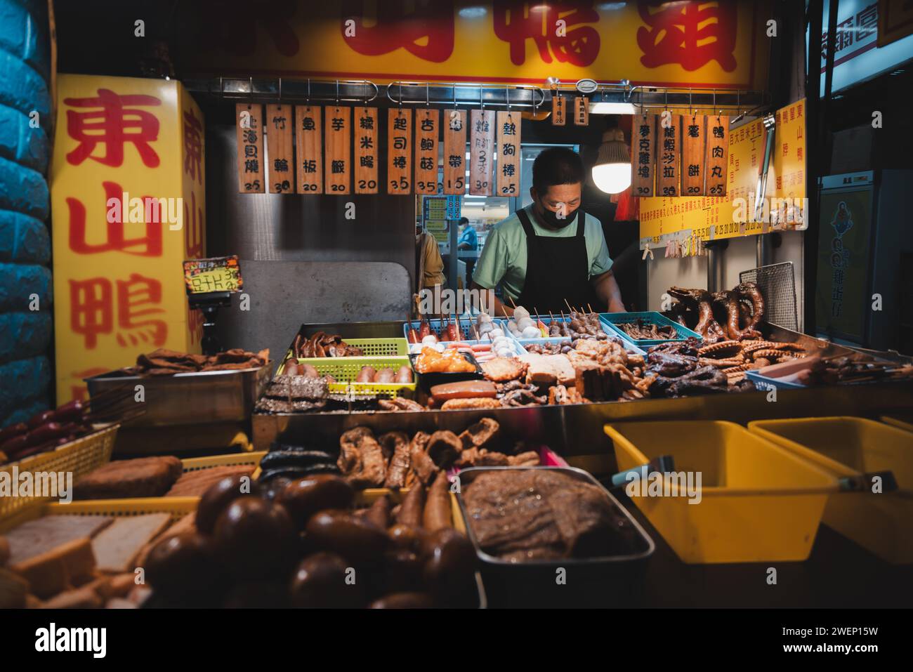 Taipei, Republic of China - October 1, 2023: Vendor selling traditional fried and barbequed meats at the busy and bustling Raohe Street Night Market i Stock Photo
