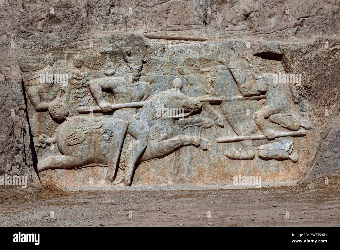 Rock relief depicts the equestrian victory of Hormizd II, Sassanid king (303-309 AD) of Persia, over a mounted foe. Naqsh-e Rostam Necropolis, Iran. Stock Photo