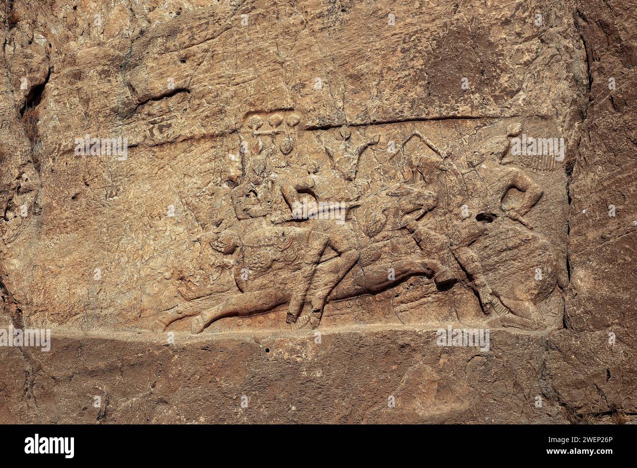 Rock relief depicts the equestrian victory of Shapur II, Sassanid king (309–379 AD) of Persia, over a mounted foe. Naqsh-e Rostam Necropolis, Iran. Stock Photo