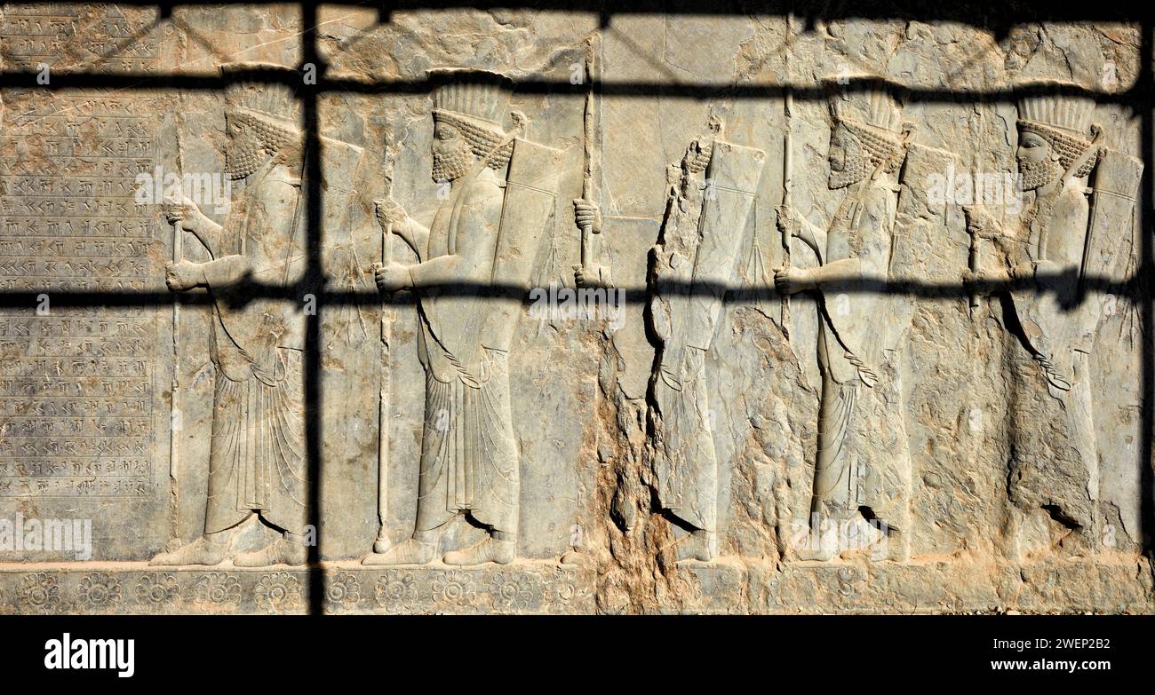 Bas-relief showing Persian soldiers in Persepolis, ceremonial capital of the Achaemenid Empire (550–330 BC). Fars Province, Iran. Stock Photo
