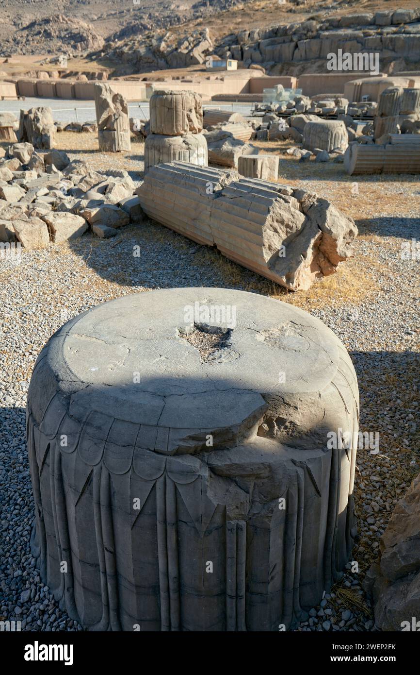 Pieces of fallen ancient columns in Persepolis, ceremonial capital of the Achaemenid Empire (550–330 BC), Iran. Stock Photo