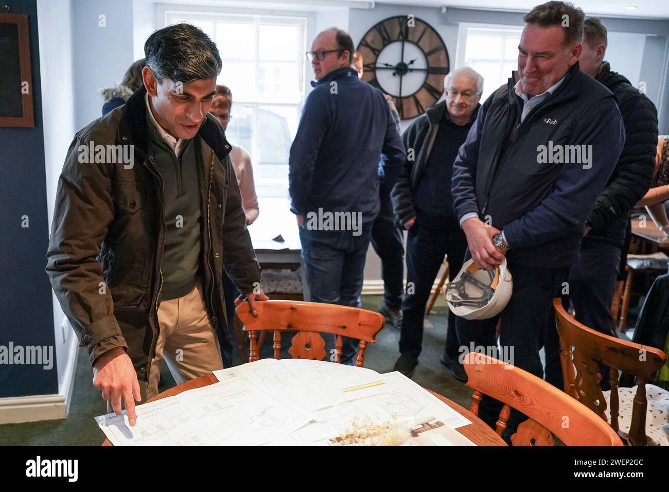 Prime Minister Rishi Sunak looks at building plans as he visits Corn